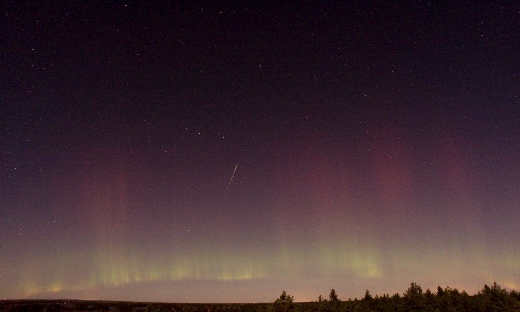 Shooting star and northern light visible in the night sky over Farnebofjardens national park near Skekarsbo, north of Stockholm, in October 2011