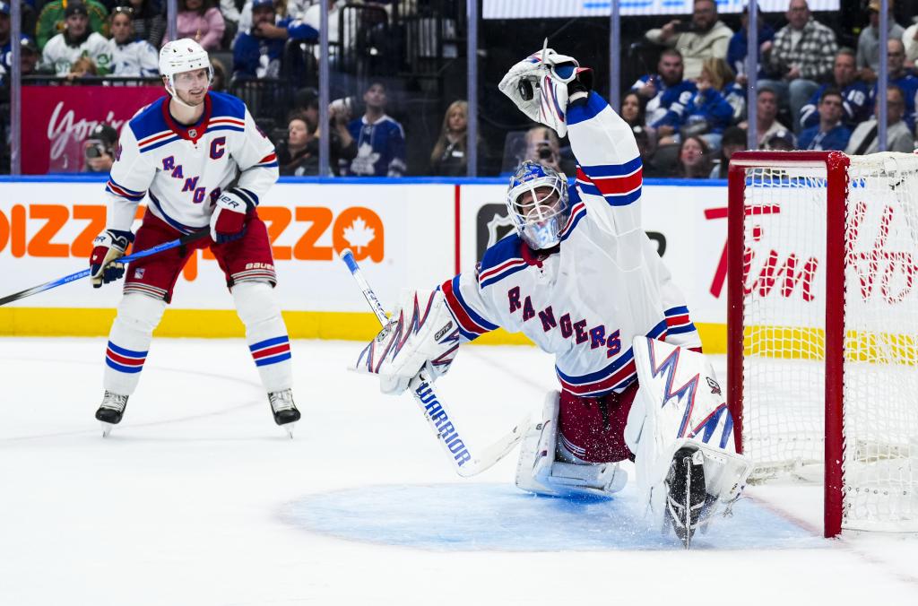 Igor Shesterkin makes a nifty glove save for one of his 34 stops in the Rangers' win.