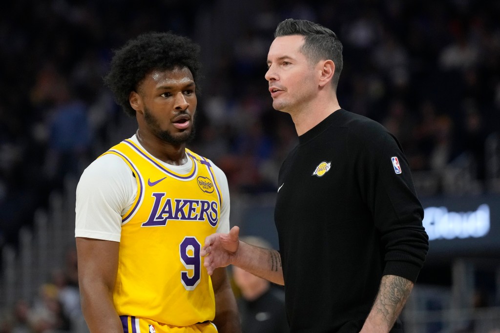 Los Angeles Lakers head coach JJ Redick, right, talks with Los Angeles Lakers guard Bronny James (9) during the first half of an NBA preseason basketball game against the Golden State Warriors in San Francisco, Friday, Oct. 18, 2024.