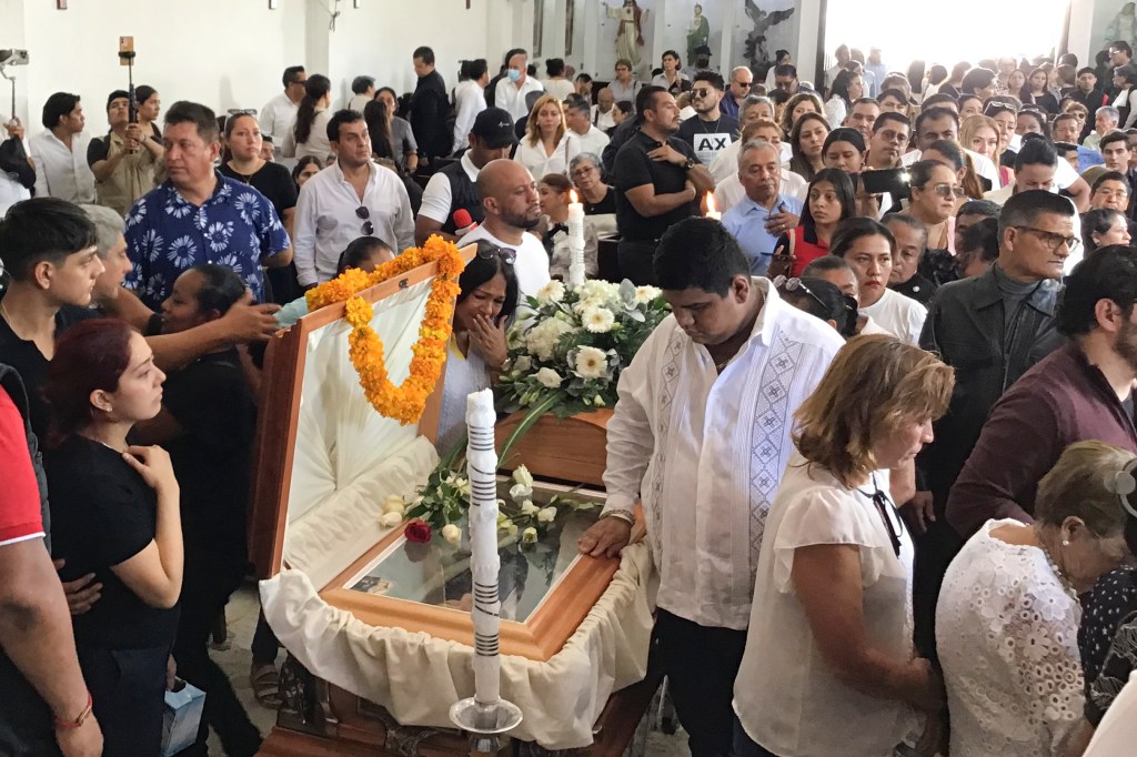 Supporters of Arcos' mourning at his funeral on Monday. 