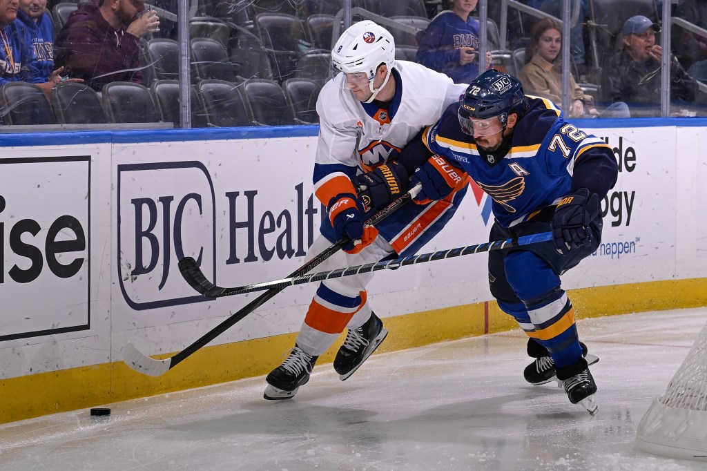 Noah Dobson battles Justin Faulk for the puck during the Islanders' loss to the Blues.