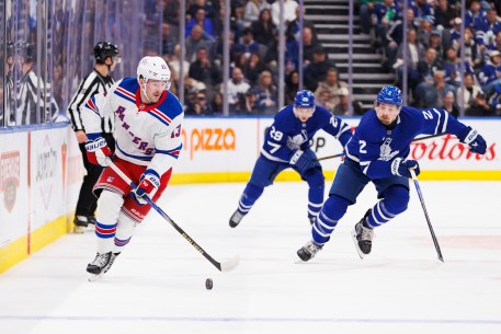 Alexis Lafreniere handles the puck against the Maple Leafs on Saturday.