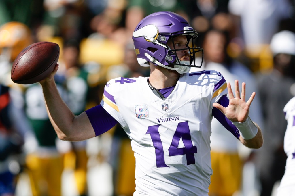 Minnesota Vikings quarterback Sam Darnold (14) looks to throw a pass during the first half of an NFL football game against the Green Bay Packers, Sunday, Sept. 29, 2024, in Green Bay, Wis.