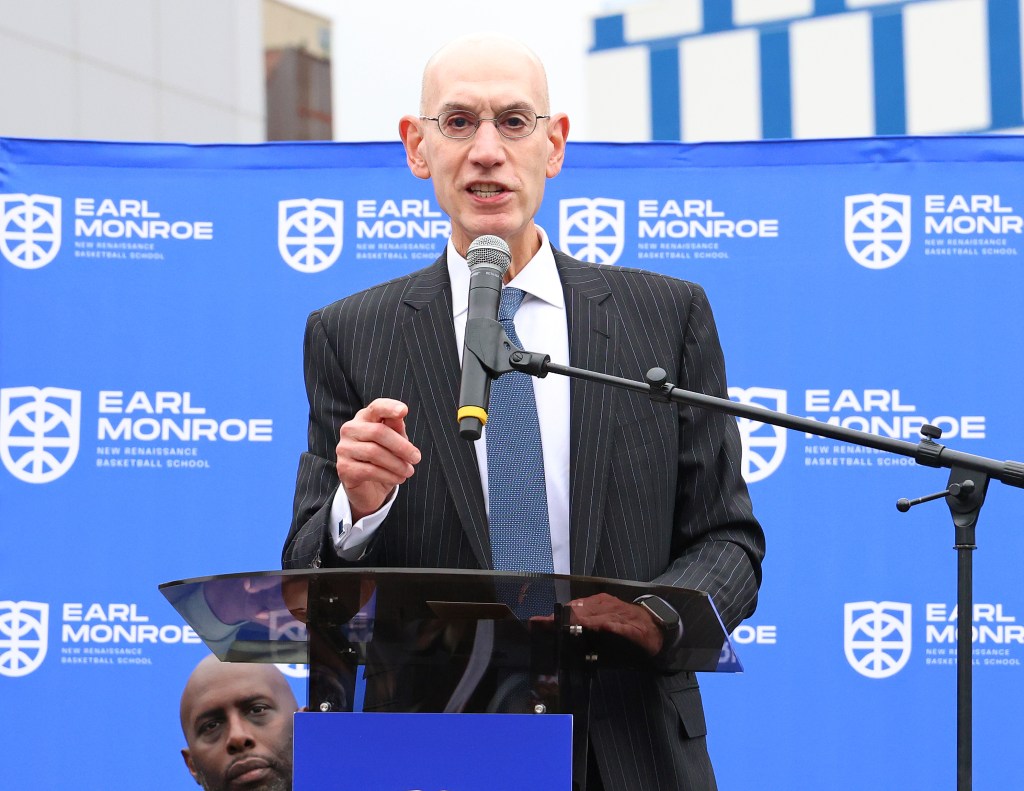 NBA Commissioner Adam Silver speaking in front of a podium,