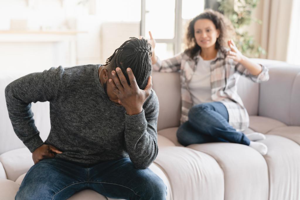 African-american wife crying arguing scolding at her husband at home.