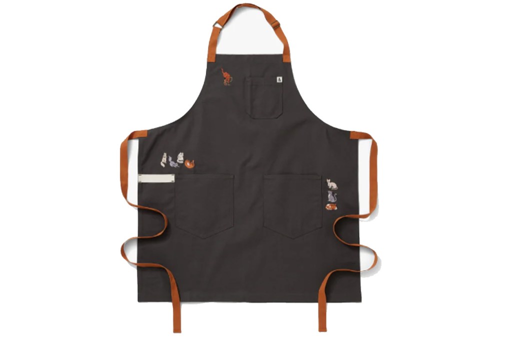 A black apron with brown straps