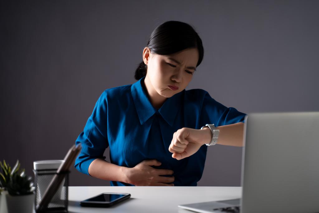 A hungry woman at her desk. 