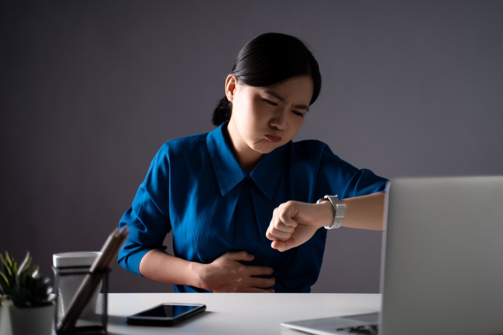 A hungry woman at her desk. 