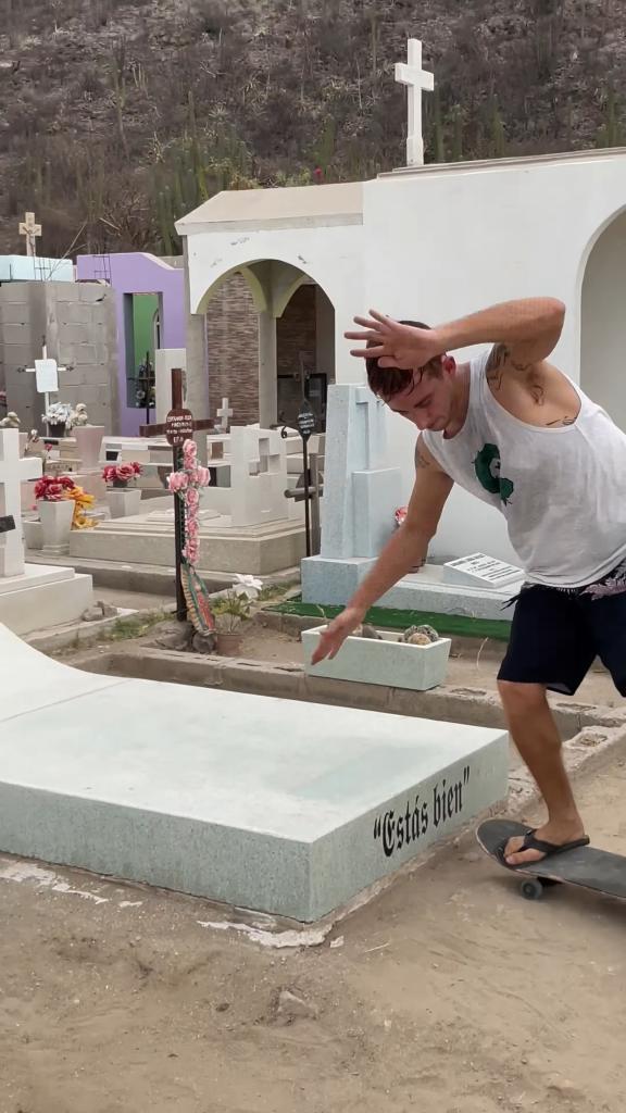 A visitor performs a trick on Castillo's grave.