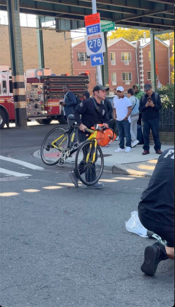 A first responder removes the bike from the crash site.