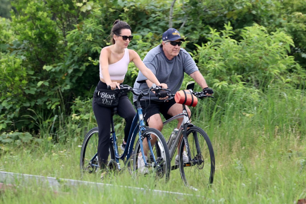 Bill Belichick and Jordon Hudson go for an early evening bike ride along the bike paths of Nantucket. 