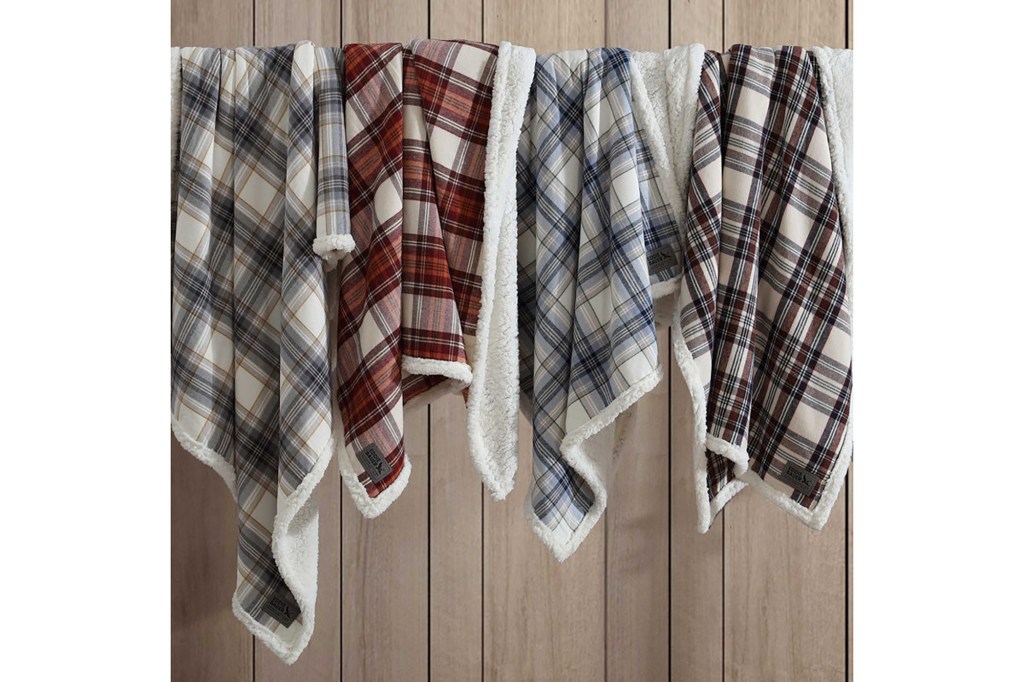 Group of plaid blankets on a rack