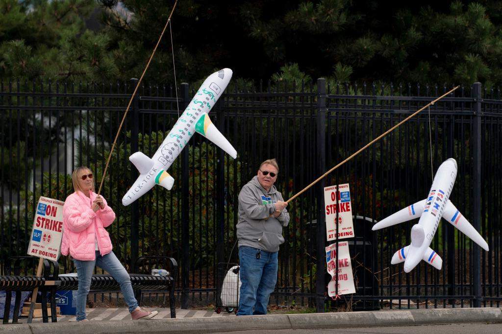 Boeing employees hold inflatable airplanes on picket lines on Oct. 11, 2024.