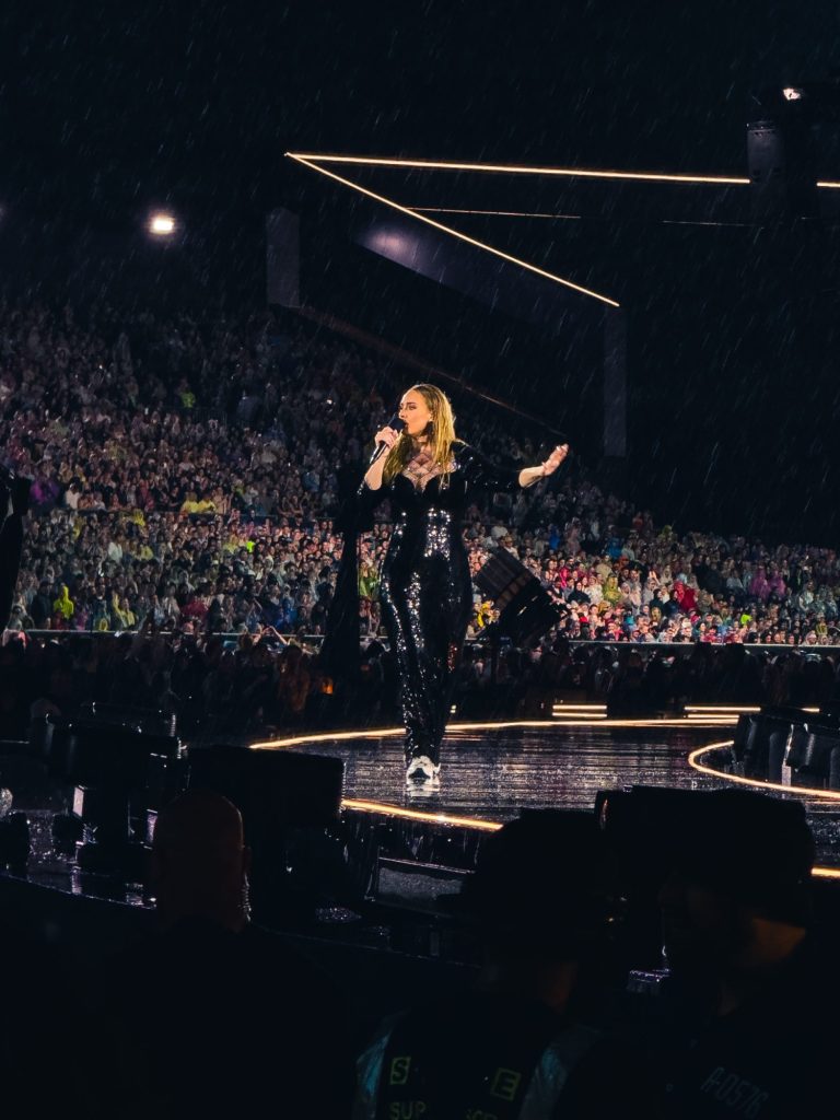 British singer Adele on stage, performing and using a t-shirt pistol to send merchandise to her audience in Munich.