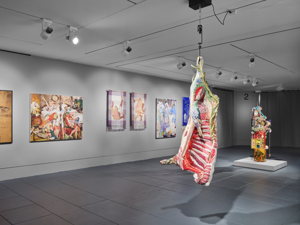 Art installation at the Brooklyn Artists Exhibition inside the Brooklyn Museum, featuring various artworks on the wall, photographed by Timothy Doyon