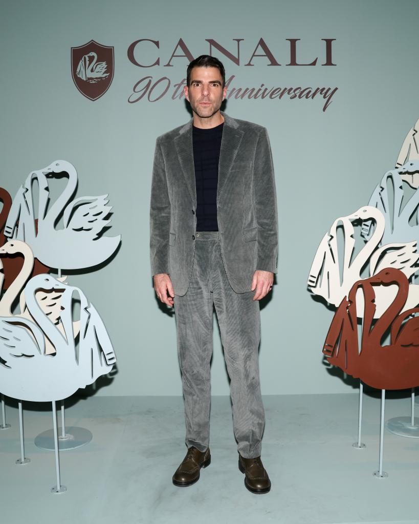 Zachary Quinto standing in front of a wall with swans at Canali's 90th Anniversary Party in New York