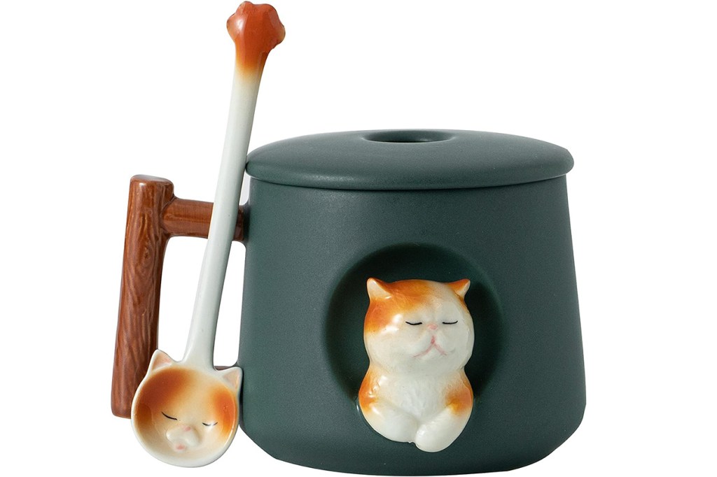 Ceramic container with a cat face and a spoon