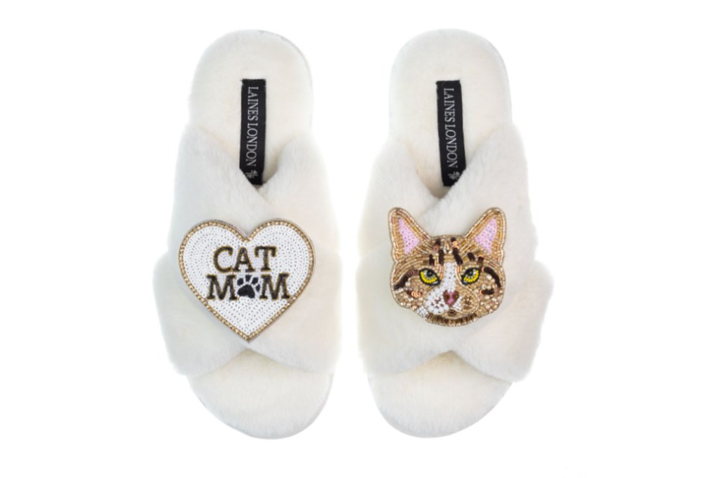 Pair of white slippers with a cat and heart design