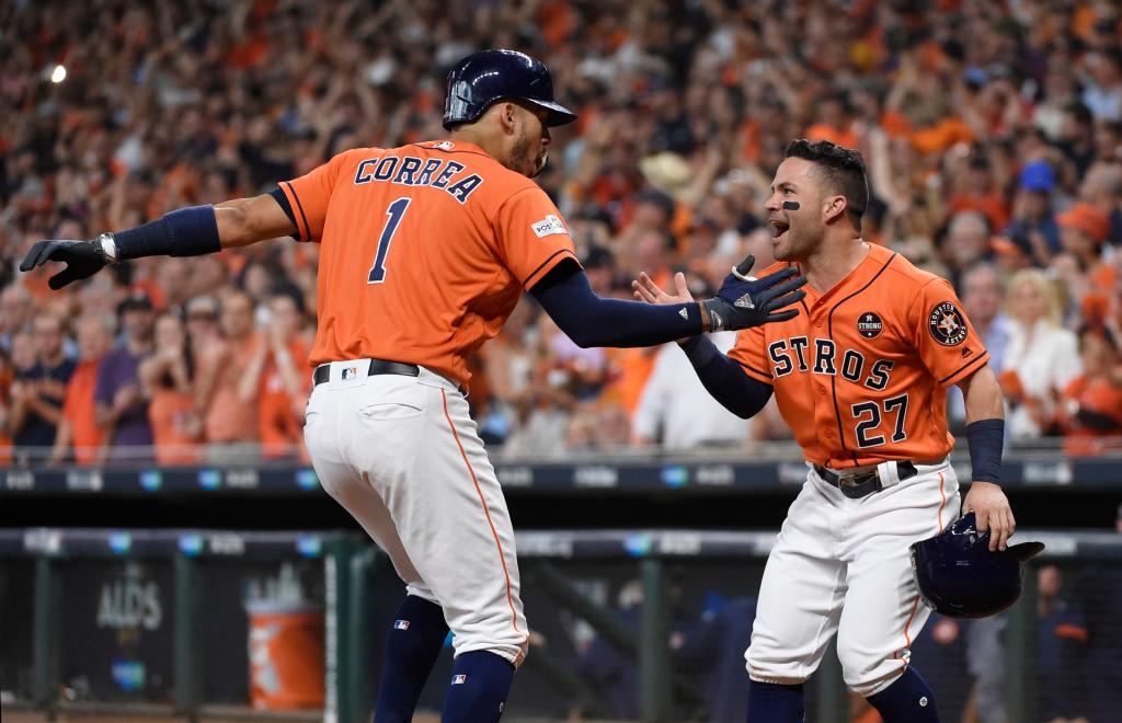 Houston Astros' Carlos Correa (1) celebrates his two-run home run with teammate Jose Altuve (27) during the first inning in Game 2 of baseball's American League Division Series against the Boston Red Sox, Friday, Oct. 6, 2017, in Houston. 