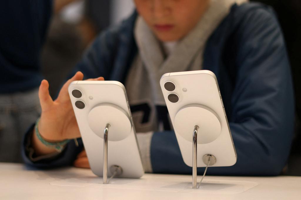 A child uses Apple iPhone smartphone displayed at a store in London, Britain, October 6, 2024. 