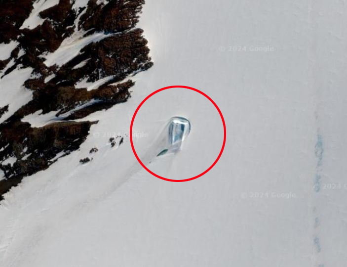 Rectangular shape resembling a doorway spotted in the snowy landscape of Antarctica, encircled in red