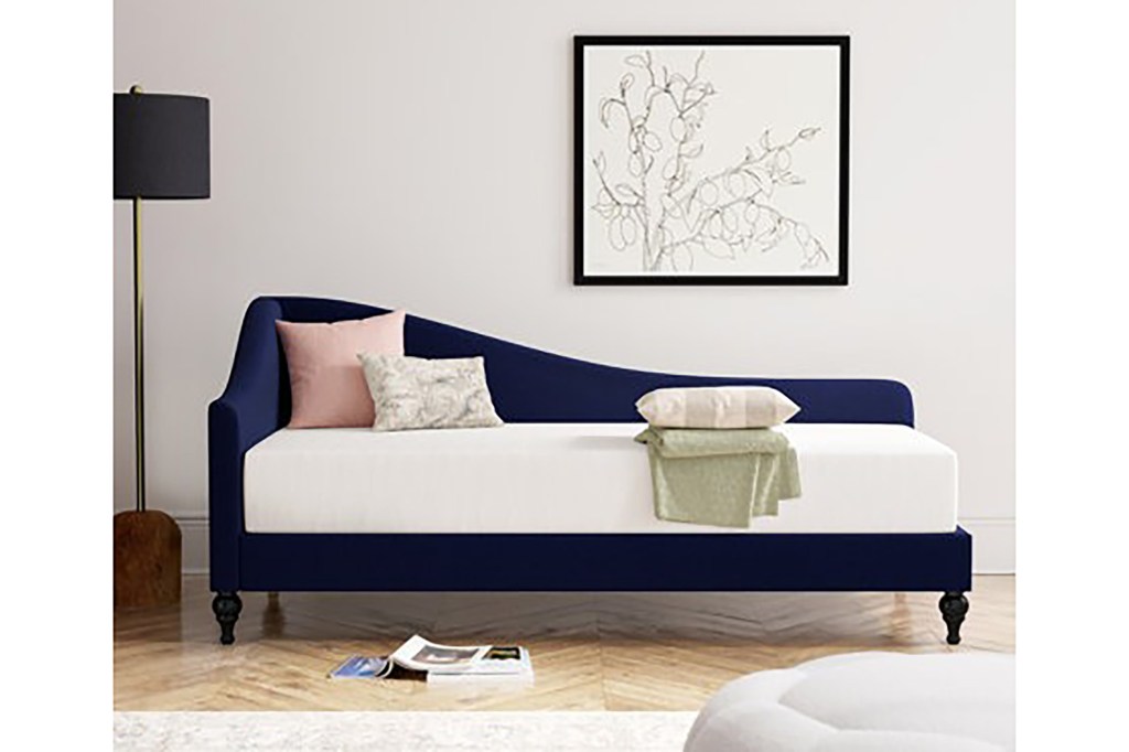 A blue and white bed with pillows