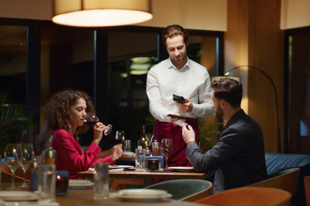 Couple paying restaurant bill in fancy night restaurant