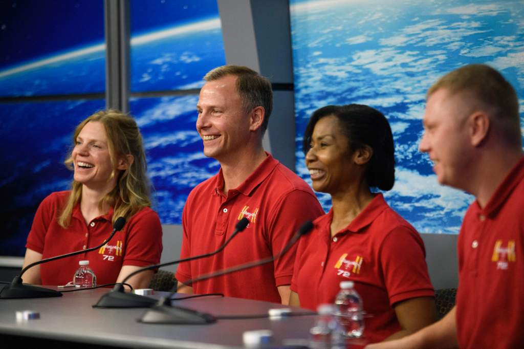 Zena Cardman (far left) and Stephanie Wilson (2nd to right) were forced to give up seats so stranded colleagues could hitch a ride back in their empty seats.