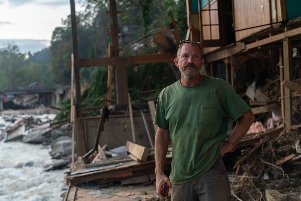 Curtis McCart, 58, standing by the remains of his home in Bat Cave.