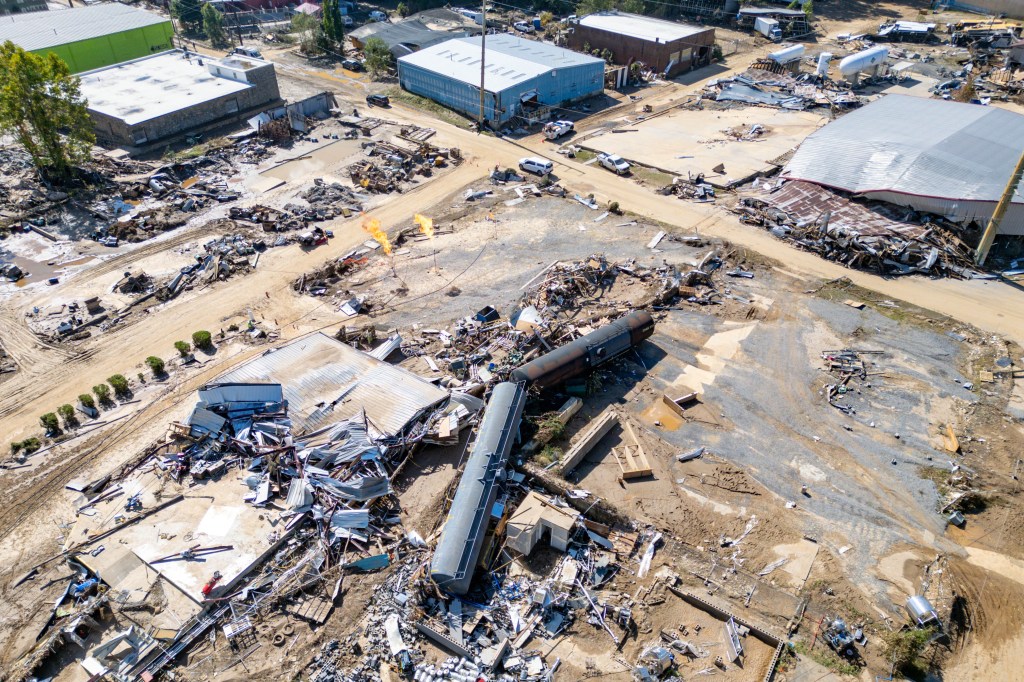 Debris and destroyed buildings surrounding the Swannanoa River in Asheville, NC, following the aftermath of Hurricane Helene.