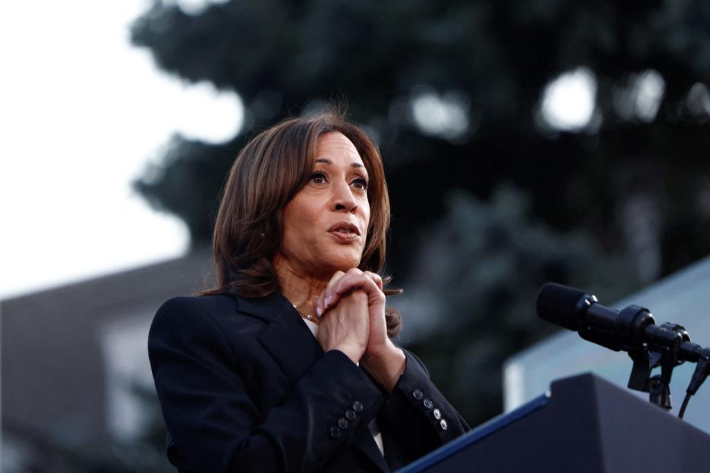 U.S. Vice President Kamala Harris delivering a speech at a campaign event in Ripon College, Wisconsin, with her hands together on the podium.
