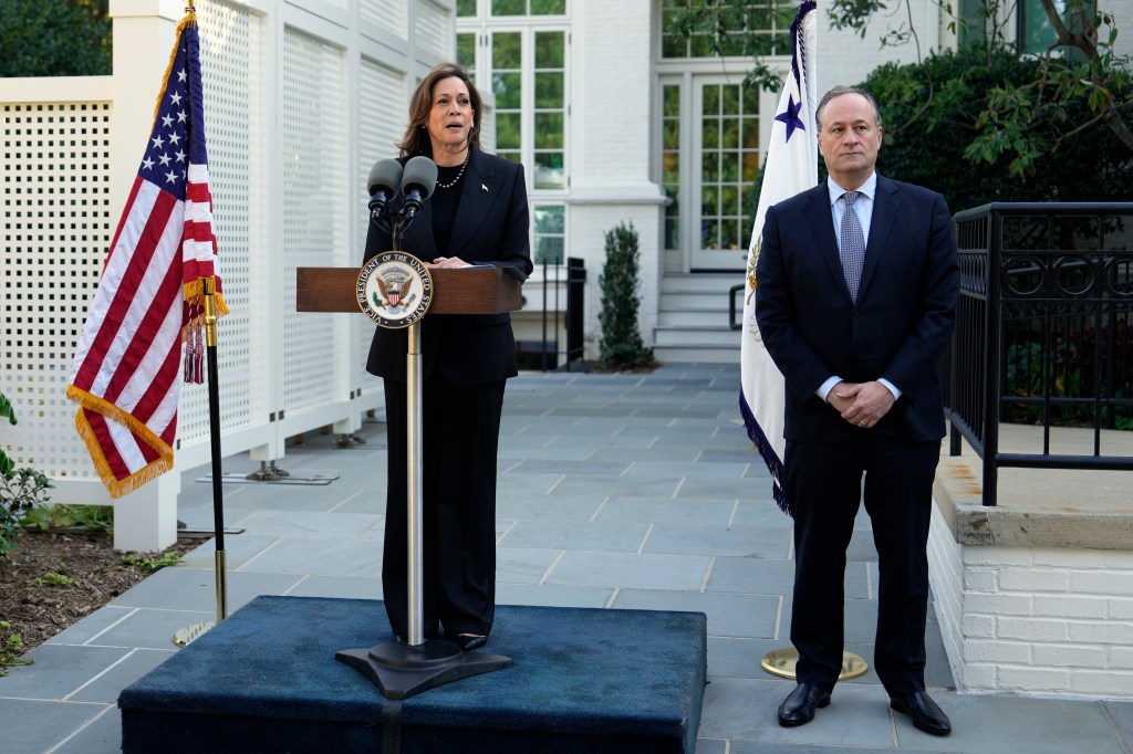 Vice President Kamala Harris speaks as second gentleman Doug Emhoff looks on before planting a memorial tree on the grounds of the Vice President's residence in Washington on Monday, Oct. 7, 2024.