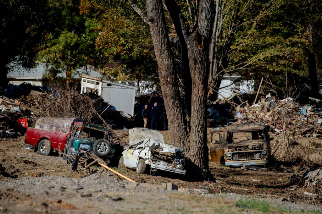 Destroyed cars are seen next to remnants of buildings in Swannanoa