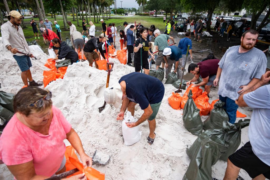 Dozens of people fill up sandbags at Donna Fiala Eagle Lakes Community Park in Naples as Hurricane Milton 