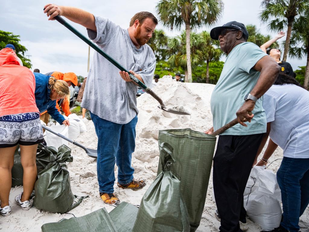 Dozens of people fill up sandbags at Donna Fiala Eagle Lakes Community Park in Naples as Hurricane Milton approaches the state