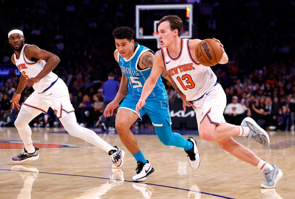 New York Knicks guard Tyler Kolek driving to the basket against Charlotte Hornets guard K.J. Simpson during a preseason basketball game at Madison Square Garden