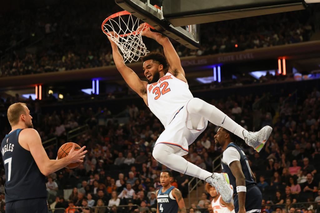 Knicks' Karl-Anthony Towns (32) dunks the ball during the first half of a preseason game.