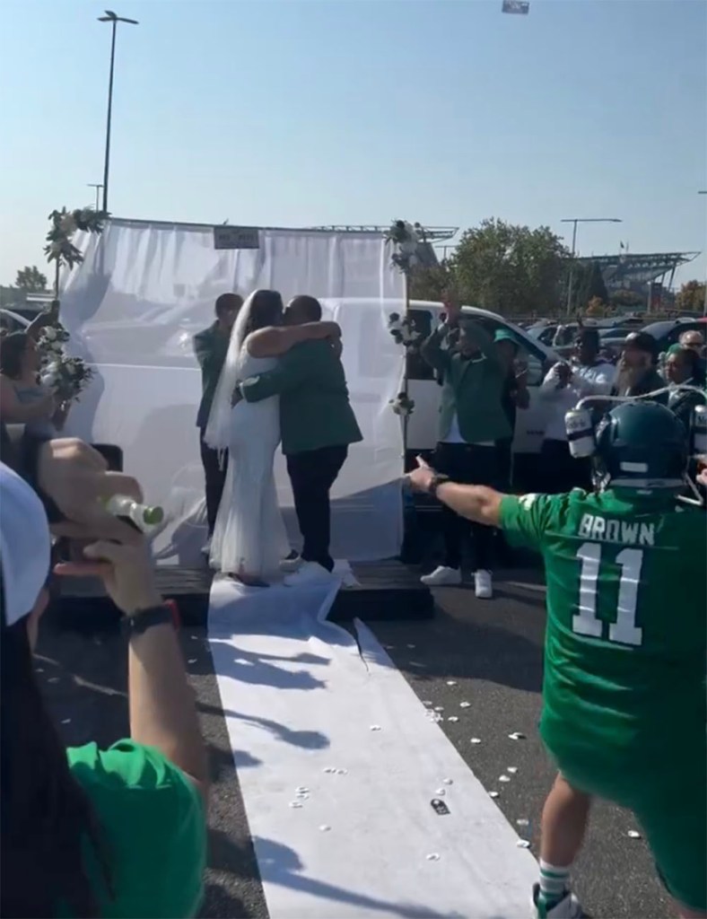 Two Eagles fans got married at a tailgate in the parking lot at Lincoln Financial Field in Philadelphia on Oct. 13, 2024. 