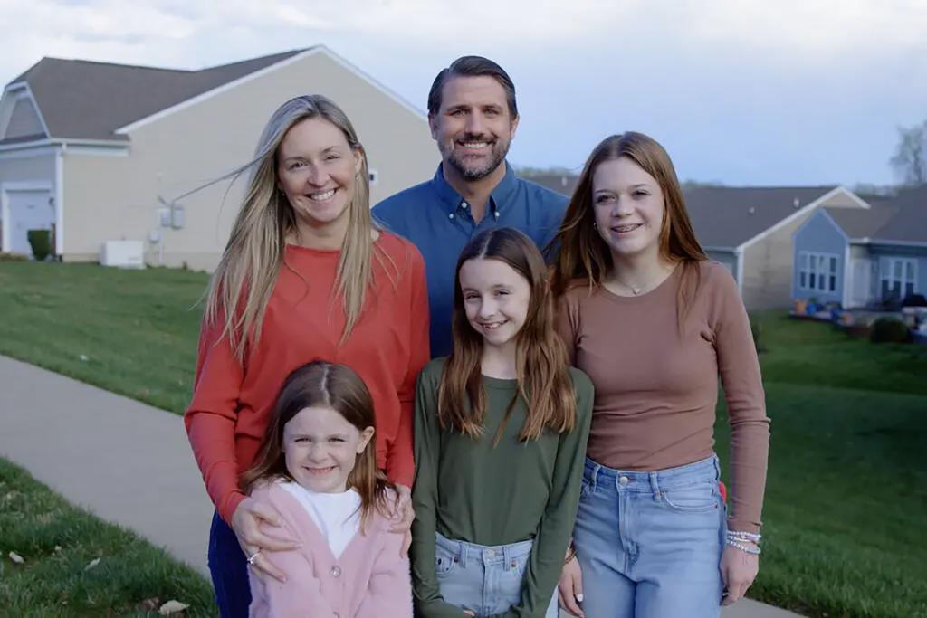 Virginia congressional candidate Derrick Anderson poses for a photo to promote his campaign —with a woman and three young girls who are not his family.