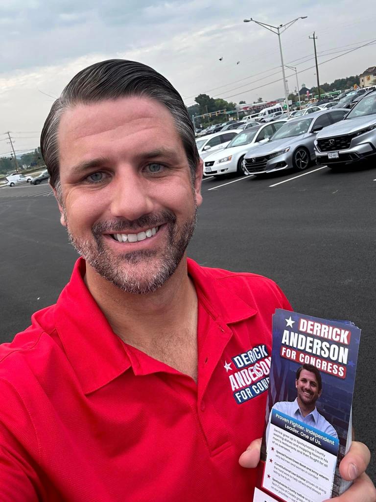 Derrick Anderson takes a selfie wearing a red polo reading "Derrick Anderson for Congress"