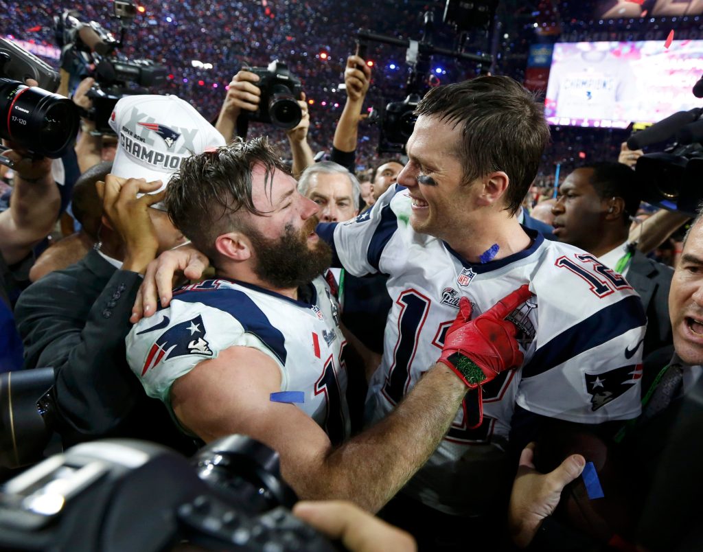 Patriots quarterback Tom Brady (12) is embraced by wide receiver Julian Edelman (11) after their team defeated the Seattle Seahawks in the NFL Super Bowl XLIX football game in Glendale, Arizona, February 1, 2015.  