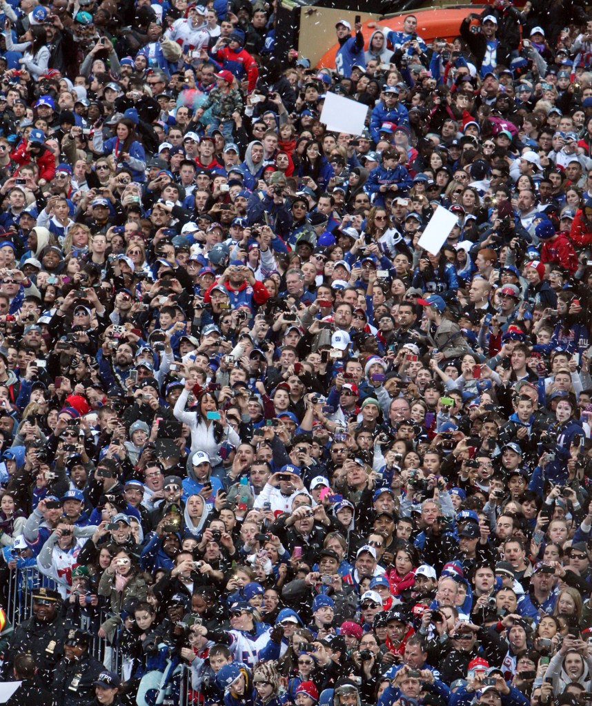 Fans cheer as the New York Giants make their way up Broadway during the Super Bowl Championship ticker-tape parade Tuesday, Feb. 7, 2012, in New York. 