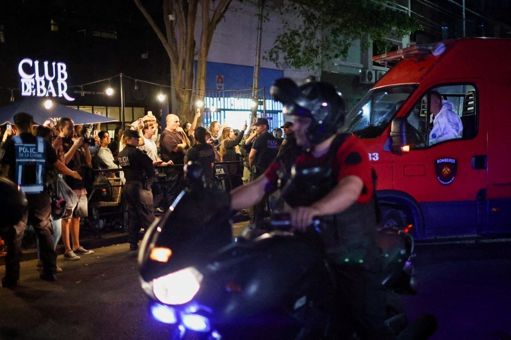 Firefighter ambulance transporting the body of Liam Payne in Buenos Aires with bystanders watching