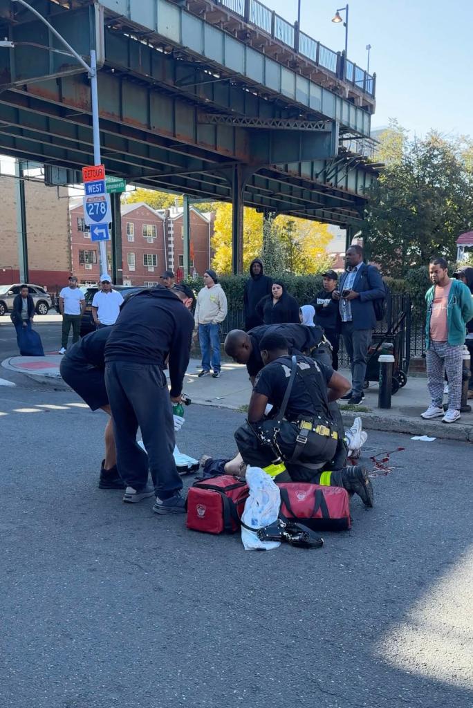 A photo of first responders attending to the fatally injured bicyclist.