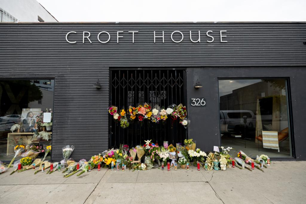 Flowers are placed outside Croft House furniture store in memory of graduate student Brianna Kupfer.