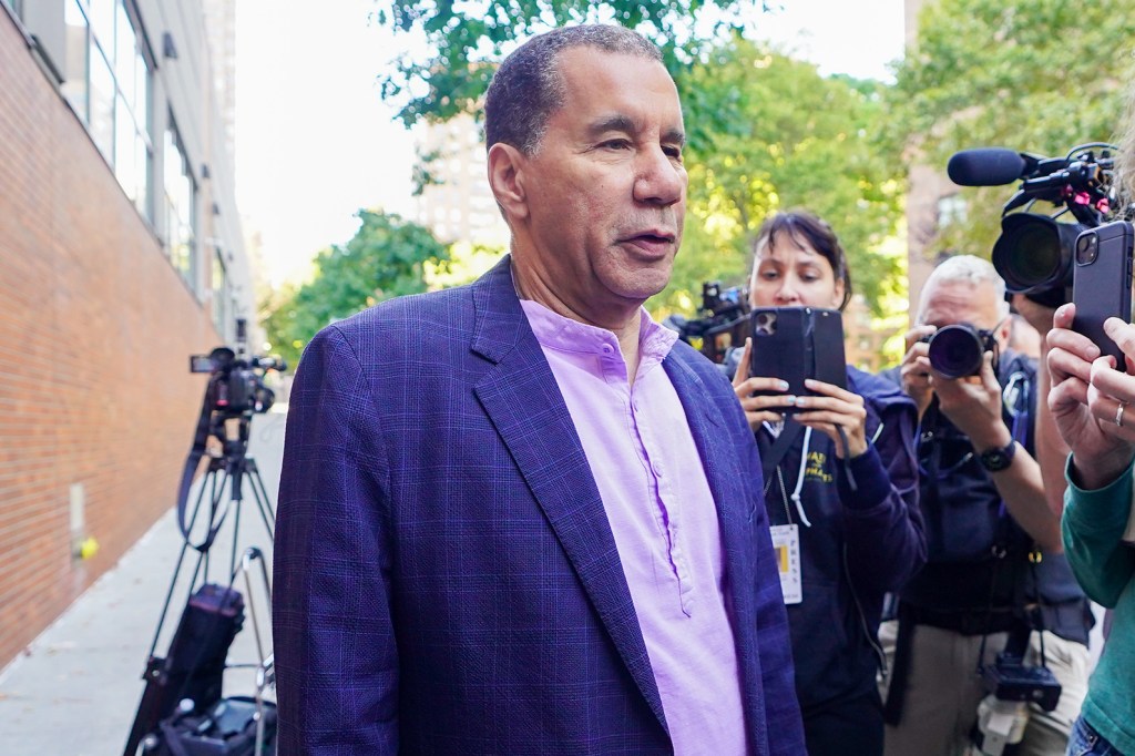 Former Gov. Paterson wearing a bright blue jacket and collarless shirt.