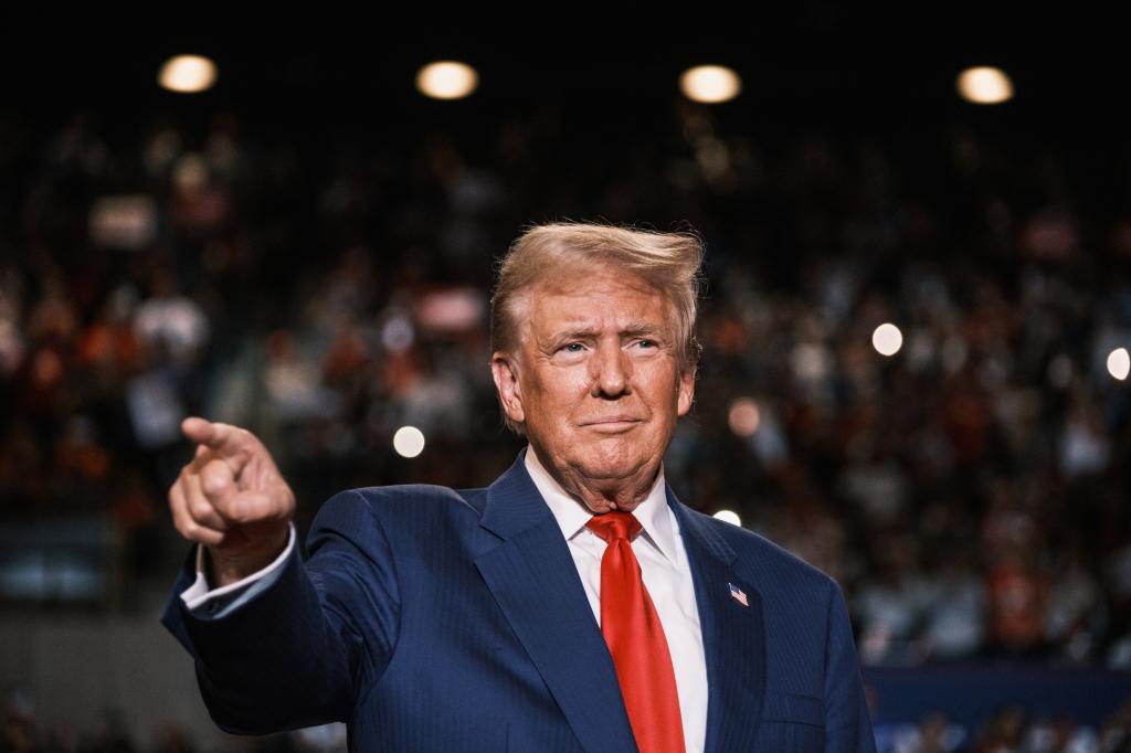 Trump speaks at campaign rally and points to audience in Hempstead, Long Island.