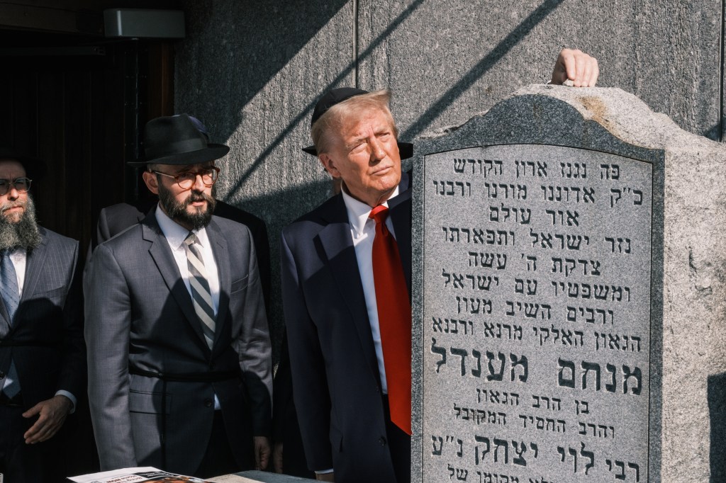 Donald Trump places a rock on a tombstone at Ohel Chabad Lubavitch, the final resting place of Rabbi Menachem M. Schneerson the Rebbe, in Queens, NYC, on Monday, October 7, 2024.