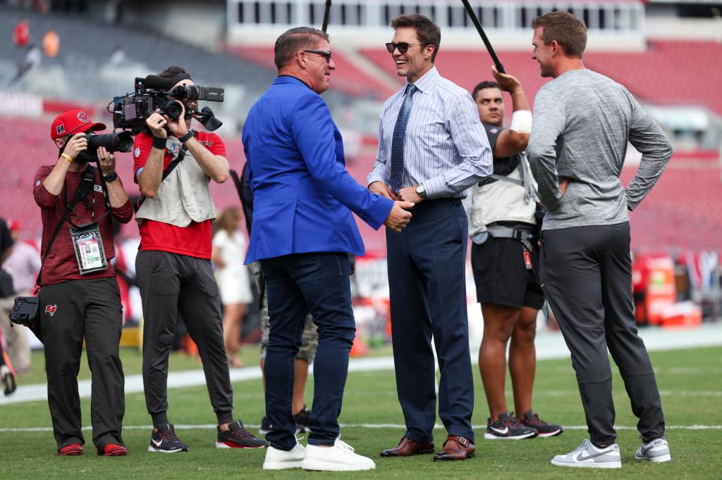 Brady talks with Buccaneers GM Jason Licht before a game.