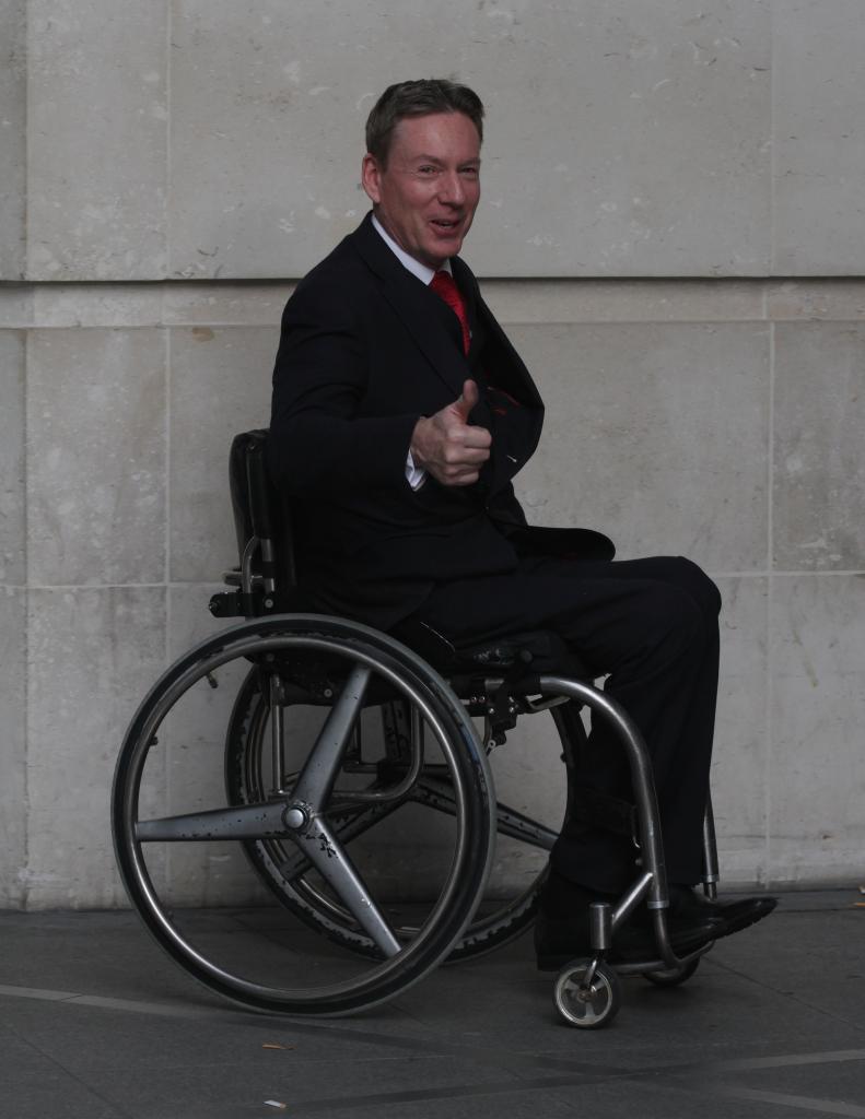 Frank Gardner, a man in a suit and tie, sitting in a wheelchair at the BBC studios in London on December 21, 2014